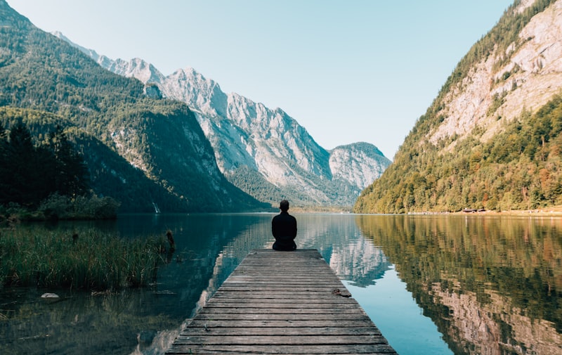 Person in serene natural setting, calm and grounded